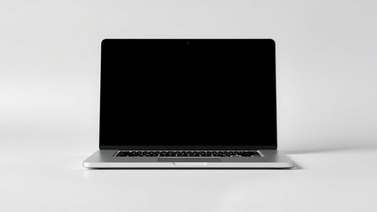 Thin aluminium laptop, open, on a plain studio background